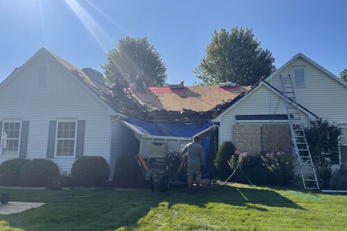 Roofman working on a residential roof replacement