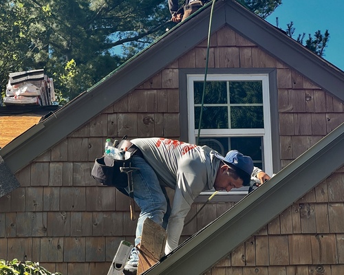 Roofman USA crew completing a roof replacement on Michigan local's home