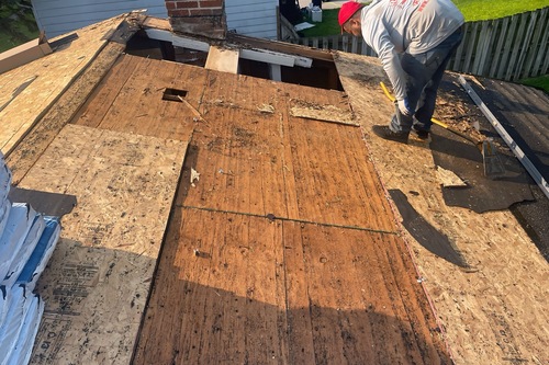 Roofing contractors working on a Warren home