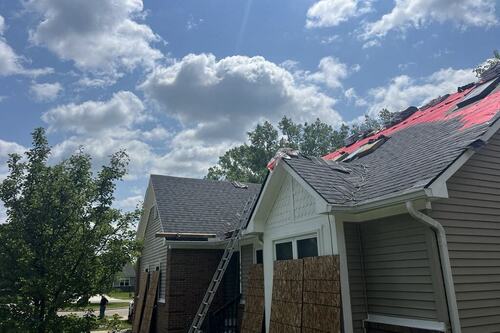 Roofing contractors working on a Belleville home