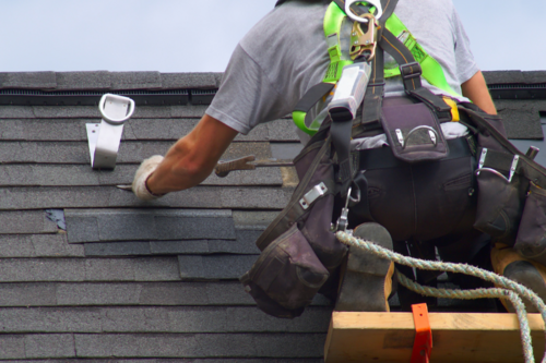 Worker inspecting roof.