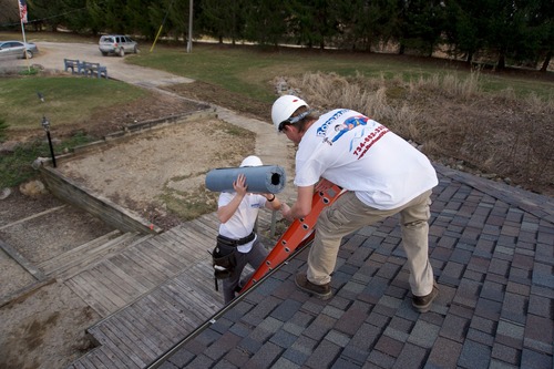 Workers on roof in Dearborn.
