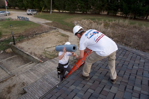 Worker on a roof in Ann Arbor.