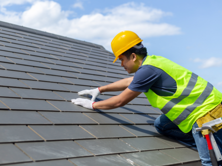 Worker completing a project on a roof in Ann Arbor. 