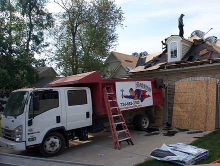 White Roofman rruck servicing a roofing project in Warren.