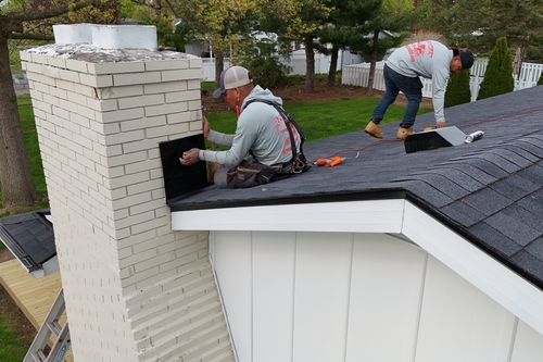 Residential roofers working in Onsted from Roofman USA working on a roof replacement project