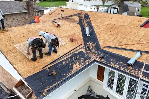 Residential roofers working on a Fowlerville Resident's home