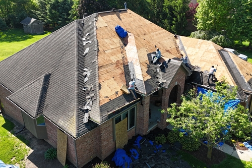 Roofman USA traveling roofing company working on Michigander's home