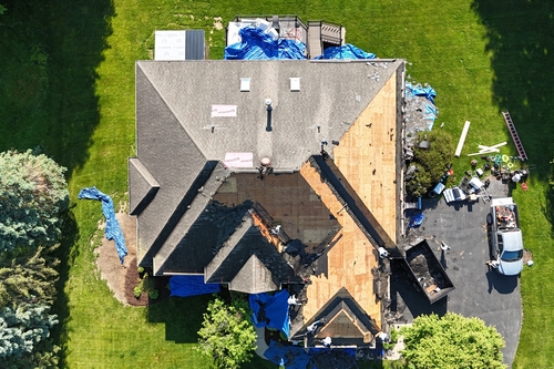 Roofman roof installers working on Michigan residents new roof installation project