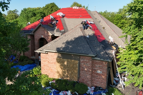 Michigan resident getting new roof installed with Roofman USA expert roofers