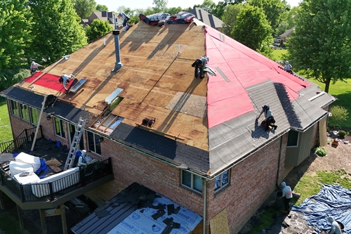 Roofman USA crew working to replace a Michigan homeowners roof using Roofman USA highly-rated materials.
